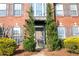 Elegant home featuring a front door flanked by lush greenery and classic brick architecture at 601 Hexham Ct, Suwanee, GA 30024