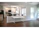 Open kitchen with an island, stainless steel appliances, and views into the living space at 601 Hexham Ct, Suwanee, GA 30024