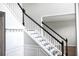 Elegant staircase with white banisters and black handrail, adding a touch of classic charm to the home at 601 Hexham Ct, Suwanee, GA 30024