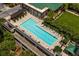 Aerial view of a pool with sun loungers on top of parking garage with buildings and trees surrounding it at 1820 Peachtree Nw St # 1110, Atlanta, GA 30309