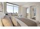 The bedroom includes a cityscape view, a seating area, and is flooded with natural light at 1820 Peachtree Nw St # 1110, Atlanta, GA 30309
