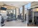 Well-equipped gym with modern exercise machines and large windows offering natural light and city views at 1820 Peachtree Nw St # 1110, Atlanta, GA 30309