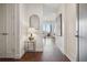 Hallway with dark wooden floor and a mirror on a side table at 1820 Peachtree Nw St # 1110, Atlanta, GA 30309