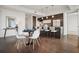 Modern kitchen with stainless steel appliances, breakfast bar, and an adjacent dining area with a round table at 1820 Peachtree Nw St # 1110, Atlanta, GA 30309