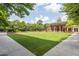 Lush green lawn surrounded by manicured gardens and a building, offering a serene outdoor space at 1820 Peachtree Nw St # 1110, Atlanta, GA 30309