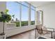Bright living room with floor-to-ceiling windows offering views of the cityscape and lush greenery at 1820 Peachtree Nw St # 1110, Atlanta, GA 30309