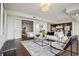 Inviting living room with dark wooden floor and view to a kitchen and an office space at 1820 Peachtree Nw St # 1110, Atlanta, GA 30309