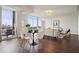 Bright living room featuring a dining area, floor-to-ceiling windows, and views of the cityscape at 1820 Peachtree Nw St # 1110, Atlanta, GA 30309