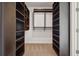Spacious walk-in closet with custom built-in shelving and hanging rods for optimal storage at 1820 Peachtree Nw St # 1110, Atlanta, GA 30309