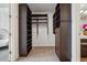 This expansive walk-in closet provides plenty of space for storage with built-in shelves and drawers at 1820 Peachtree Nw St # 1110, Atlanta, GA 30309