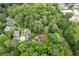 Aerial view showcasing a home nestled in a lush, tree-filled neighborhood with mature canopies and green spaces at 1909 Moores Mill Nw Rd, Atlanta, GA 30318