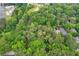 A neighborhood aerial shot with mature trees surrounding residential properties, creating a verdant and tranquil setting at 1909 Moores Mill Nw Rd, Atlanta, GA 30318
