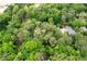 Aerial view highlighting a home surrounded by mature trees, offering a serene and private setting in a lush neighborhood at 1909 Moores Mill Nw Rd, Atlanta, GA 30318