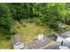 Aerial view of the home with a large backyard, pool and wooden deck surrounded by mature trees and lush greenery at 1909 Moores Mill Nw Rd, Atlanta, GA 30318
