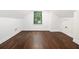 Finished attic space features hardwood floors, white walls and trim, and a window with backyard view at 1909 Moores Mill Nw Rd, Atlanta, GA 30318