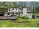 Back exterior view of the home, complete with a wooden deck and grill, surrounded by a wooded lot at 1909 Moores Mill Nw Rd, Atlanta, GA 30318