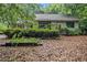 Exterior shot of home with a deck, mature landscaping, and a quaint backyard at 1909 Moores Mill Nw Rd, Atlanta, GA 30318