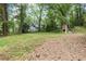 Spacious backyard featuring a detached garage and lush greenery at 1909 Moores Mill Nw Rd, Atlanta, GA 30318