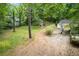 A spacious backyard featuring a fire pit, storage shed, and lush greenery, creating a private retreat at 1909 Moores Mill Nw Rd, Atlanta, GA 30318
