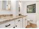 Bright bathroom with granite countertop, white cabinets, tile floors and backsplash, plus window at 1909 Moores Mill Nw Rd, Atlanta, GA 30318