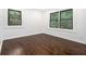Cozy bedroom with hardwood floors, white walls, base board trim, and natural light from surrounding trees at 1909 Moores Mill Nw Rd, Atlanta, GA 30318