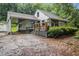 Exterior view of home with covered parking, deck, and mature landscaping at 1909 Moores Mill Nw Rd, Atlanta, GA 30318