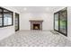 Open living area with wood burning fireplace, accent wall, designer tile floor, and sliding glass doors to backyard at 1909 Moores Mill Nw Rd, Atlanta, GA 30318