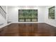 Spacious living room with hardwood floors, large windows, and stairs visible at 1909 Moores Mill Nw Rd, Atlanta, GA 30318