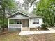 Charming single-story home with a welcoming front porch and beautifully landscaped yard at 2037 Lakewood Trl Se, Atlanta, GA 30315