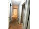 Hallway with neutral paint, carpet flooring, and access to bedrooms at 2037 Lakewood Trl Se, Atlanta, GA 30315