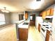 Charming eat-in kitchen next to dining room with wood cabinets, and white appliances at 2037 Lakewood Trl Se, Atlanta, GA 30315