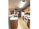 Eat-in kitchen with stainless steel sink and white appliances next to the living room at 2037 Lakewood Trl Se, Atlanta, GA 30315