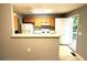 Eat-in kitchen with gray walls and wood cabinets featuring a breakfast bar and access to the back deck at 2037 Lakewood Trl Se, Atlanta, GA 30315