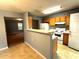 Eat-in kitchen with gray walls and wood cabinets looking into the living room at 2037 Lakewood Trl Se, Atlanta, GA 30315