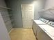Practical laundry area with washer, dryer, storage shelves, and a window at 2037 Lakewood Trl Se, Atlanta, GA 30315