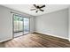 Bedroom featuring a ceiling fan, hardwood floors, and sliding glass door at 2638 Stoney Creek Rd, Marietta, GA 30067