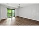 Bright bedroom with hardwood floors, ceiling fan, and sliding glass door to balcony at 2638 Stoney Creek Rd, Marietta, GA 30067