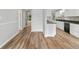 Bright kitchen featuring white cabinets, granite countertops, a black dishwasher, and luxury vinyl plank flooring at 2638 Stoney Creek Rd, Marietta, GA 30067