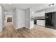 Modern kitchen with white cabinets, granite countertops, stainless steel appliances, and luxury vinyl plank flooring at 2638 Stoney Creek Rd, Marietta, GA 30067
