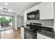 Well-lit kitchen featuring modern appliances, granite countertops, white cabinets, and luxury vinyl plank flooring at 2638 Stoney Creek Rd, Marietta, GA 30067