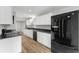 Stylish kitchen showcasing stainless steel appliances, white cabinets, granite countertops, and luxury vinyl plank flooring at 2638 Stoney Creek Rd, Marietta, GA 30067