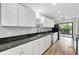 Spacious kitchen featuring granite countertops, stainless steel appliances, white cabinets, and luxury vinyl plank flooring at 2638 Stoney Creek Rd, Marietta, GA 30067