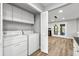 Convenient laundry area with washer, dryer, and extra storage space; adjacent to a living area with modern floors at 2638 Stoney Creek Rd, Marietta, GA 30067