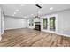 Open living room featuring luxury vinyl plank flooring, modern lighting, a fireplace, and french doors at 2638 Stoney Creek Rd, Marietta, GA 30067