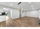 Expansive living room with modern lighting, luxury vinyl plank flooring, and seamless transition to the updated kitchen at 2638 Stoney Creek Rd, Marietta, GA 30067