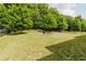 Spacious backyard with green grass and shady trees at 3241 Alhambra Cir, Hampton, GA 30228