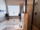 Bright bathroom with a shower, bathtub and a large window at 3241 Alhambra Cir, Hampton, GA 30228