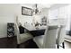 Elegant dining room featuring dark wood floors, a modern chandelier, and ample natural light at 3241 Alhambra Cir, Hampton, GA 30228