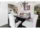 Bright dining room with dark wood floors, modern lighting, and stylish decor, perfect for entertaining at 3241 Alhambra Cir, Hampton, GA 30228