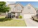 Charming two-story home featuring a gray brick exterior, well-manicured lawn, and an attached two-car garage at 3241 Alhambra Cir, Hampton, GA 30228